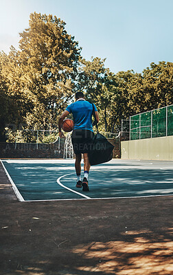 Basketball player, fitness training athlete and walk with equipment on outdoor court. African American sports man, healthy ball exercise motivation and athletic lifestyle workout on city field
