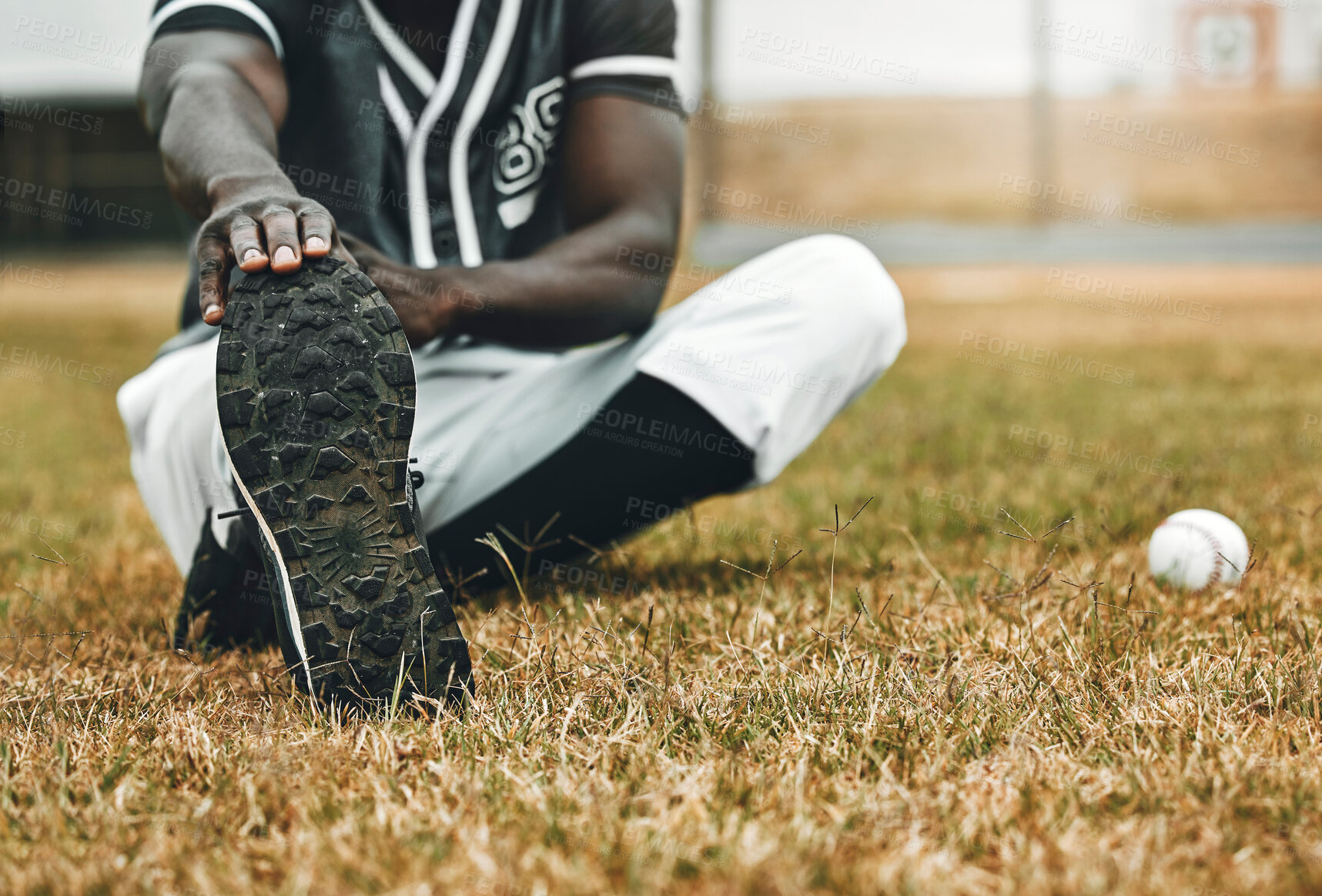 Buy stock photo Baseball player, stretching legs and athlete black man on sports field doing warm up exercise, workout and practice for match. Fitness male touch feet for health, wellness and energy on outdoor pitch