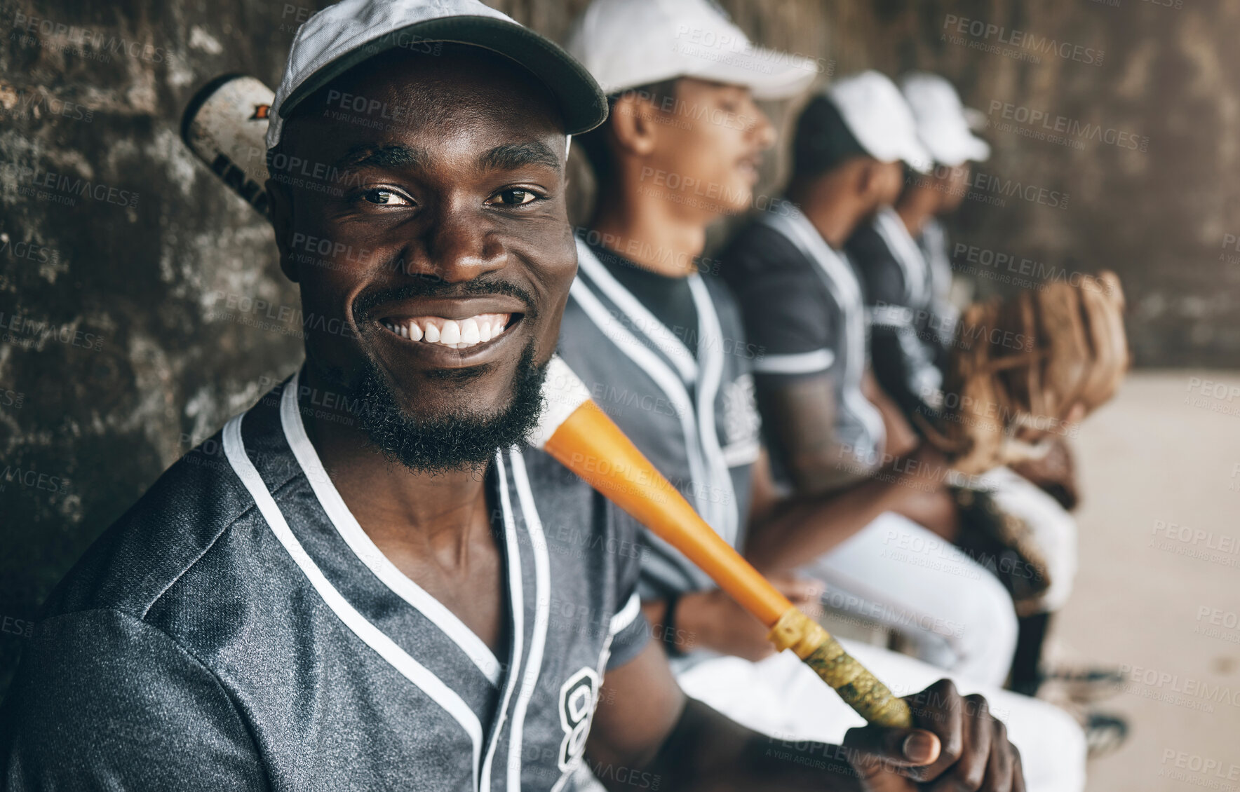 Buy stock photo Baseball, sports and face with a man athlete holding a bat in a dugout with his teammates during a game or match. Portrait, happy and fitness with a baseball player sitting ready to play on the bench