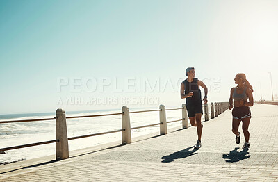 Buy stock photo Fitness, couple and running for exercise by beach in workout, training and cardio in South Africa outdoors. Active man and woman in sports run by the ocean in sea point for healthy exercising outside