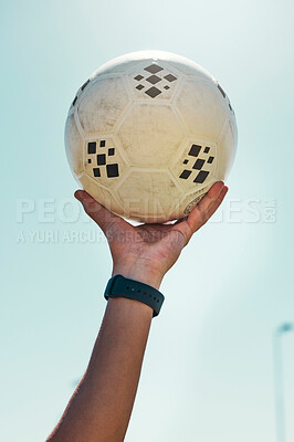 Buy stock photo Hand, soccer ball and sport motivation for football, fitness and exercise isolated against a blue sky background. Hands of active athlete holding ball in sports training, achievement or trophy win