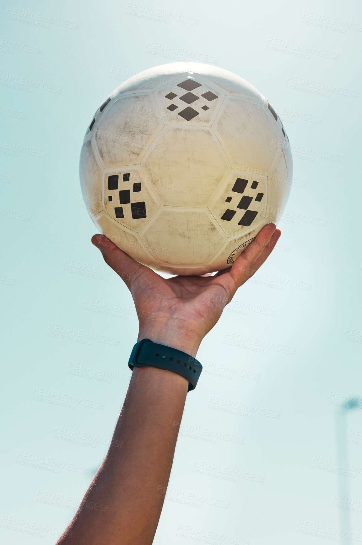 Buy stock photo Hand, soccer ball and sport motivation for football, fitness and exercise isolated against a blue sky background. Hands of active athlete holding ball in sports training, achievement or trophy win