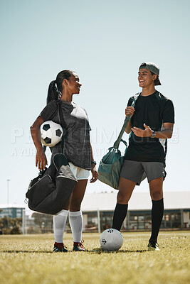 Soccer ball, woman or man on grass field after fitness, training or exercise for competition game or match. Smile, happy or talking football players, sports people or team after energy health workout