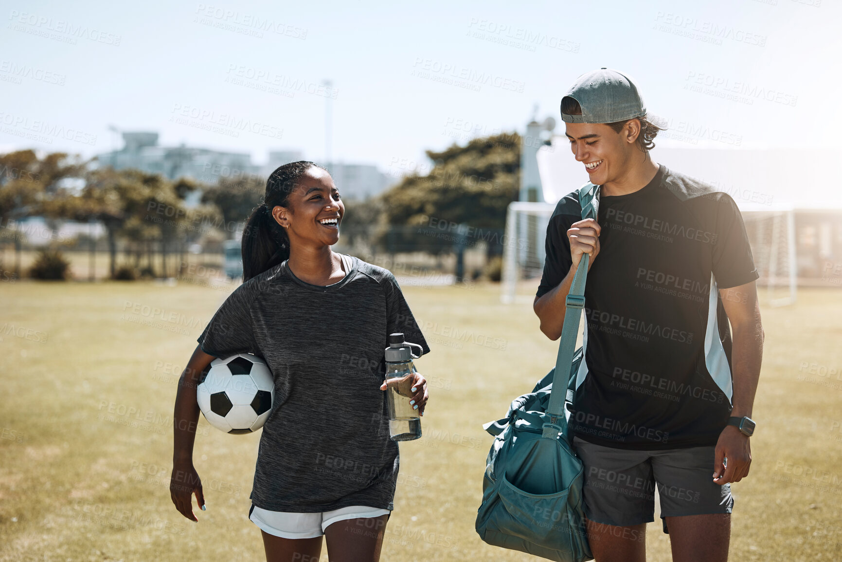 Buy stock photo Soccer players, people or team walking after fitness, training and workout on grass field. Smile, happy and talking football friends, couple or man and woman bonding after sports exercise or wellness