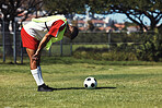 Man, stretching and soccer ball on field in warmup, training and workout outdoor in summer. Exercise, soccer player and football on grass in sunshine for sport, health and performance in development