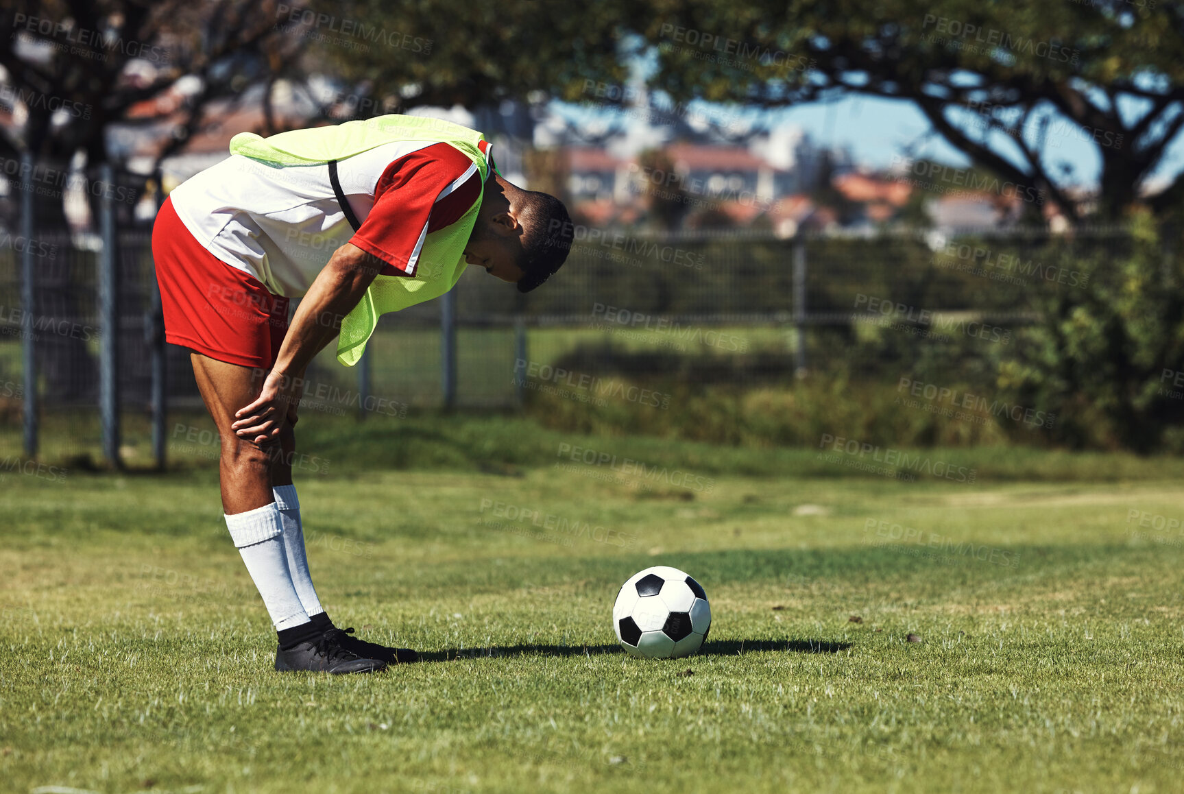 Buy stock photo Man, tired and soccer ball on field in training, warmup or workout outdoor in summer. Exercise, soccer player and rest by football on grass in sunshine for sport, health or performance in development