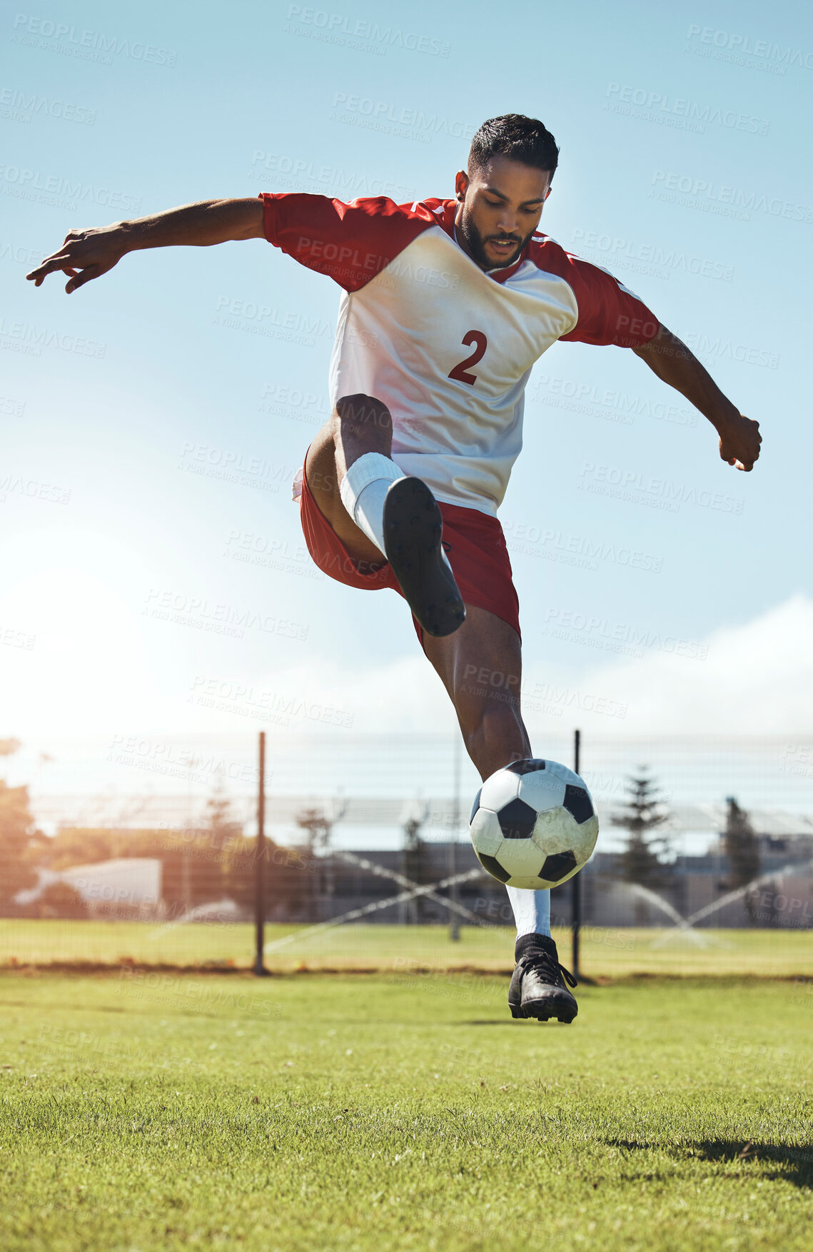 Buy stock photo Man, soccer and ball tricks in sports, fitness and exercise for training, workout or practice on the field in the outdoors. Athletic active soccer player in football sport trick, motivation or cardio