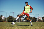 Soccer, sports and game energy of a man athlete from Israel in a fitness workout and training kick. Exercise, football and healthy cardio of a person with match focus on field grass in summer 