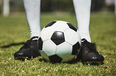 Buy stock photo Soccer ball, football player and game of athlete on a sports field for a match wearing shoes. Fitness, training exercise and cardio health of male feet with energy on field, green grass or pitch