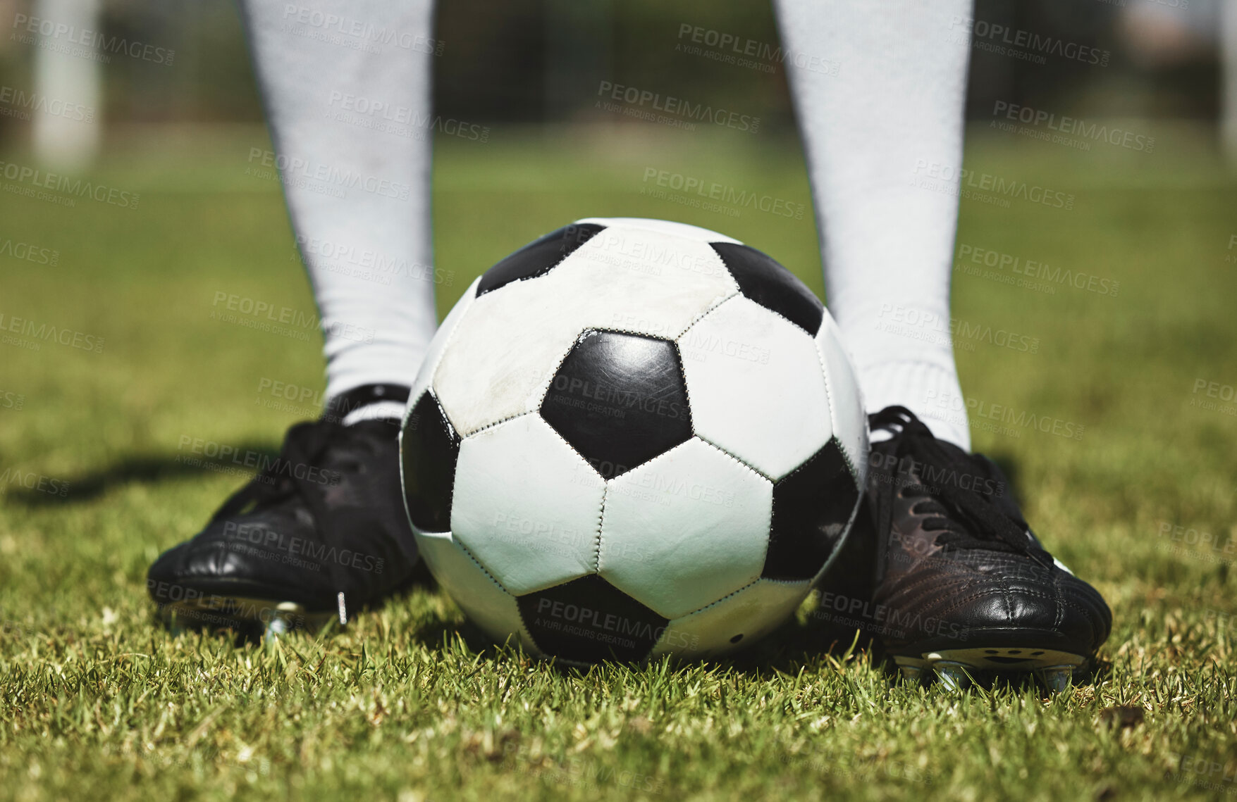 Buy stock photo Soccer ball, football player and game of athlete on a sports field for a match wearing shoes. Fitness, training exercise and cardio health of male feet with energy on field, green grass or pitch