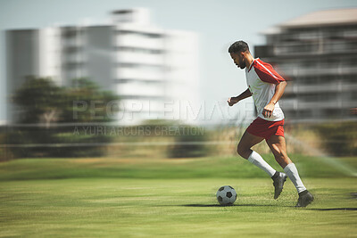 Buy stock photo Football, fitness and soccer player running on the field to score goals in a sports match or training game outdoors. Blur, Brazil and young athlete doing cardio exercise, practice or workout on grass