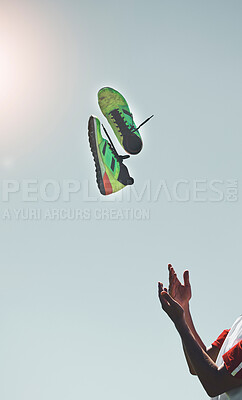 Buy stock photo Soccer, shoes and player throw in the air, after practice and for winning to celebrate, football victory and outdoor in summer. Mockup space, hands and cleats for training, motivation and sportswear