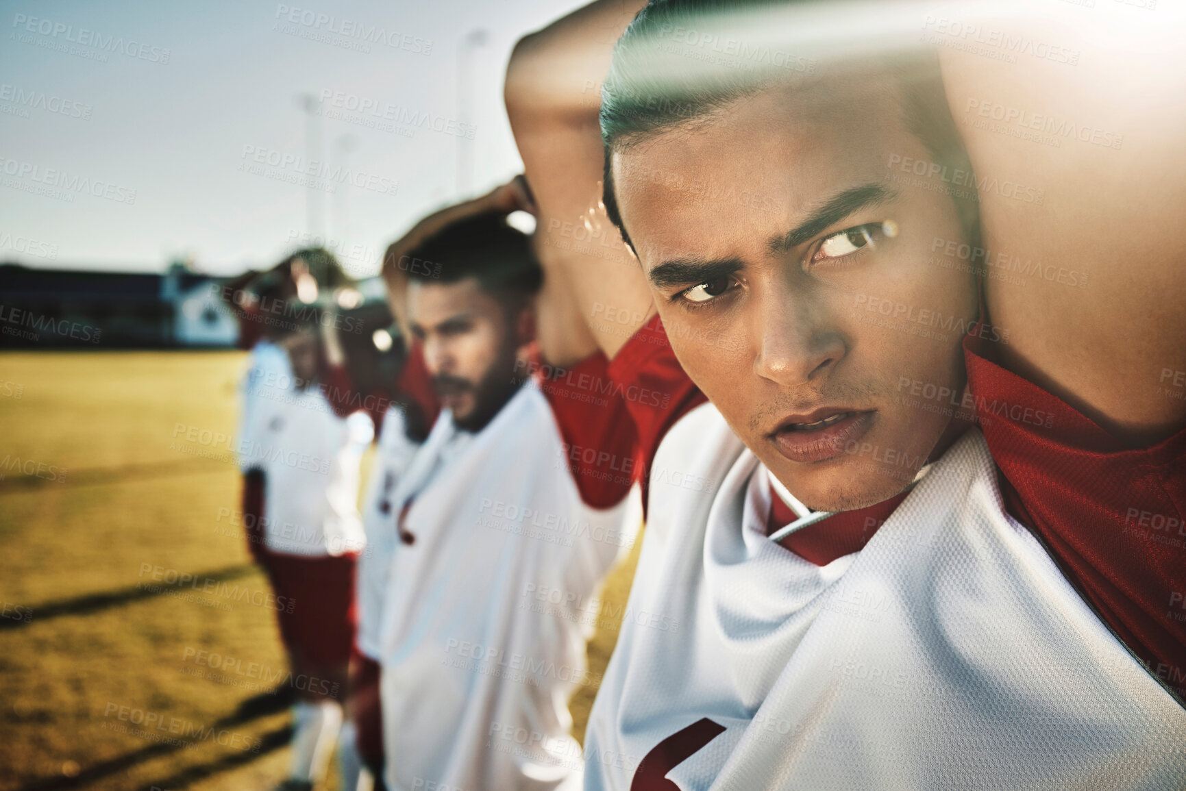 Buy stock photo Face, soccer and stretching with a sports man getting ready for a game or workout with his team on a grass pitch or field. Football, fitness and training with a male athlete warming up for exercise