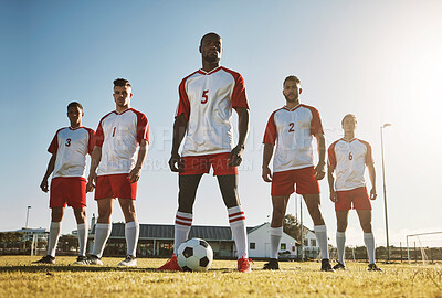 Soccer player, team and sports training on soccer field by men standing with ball, power and strong mindset. Football, fitness and man football players united in support on football field for workout