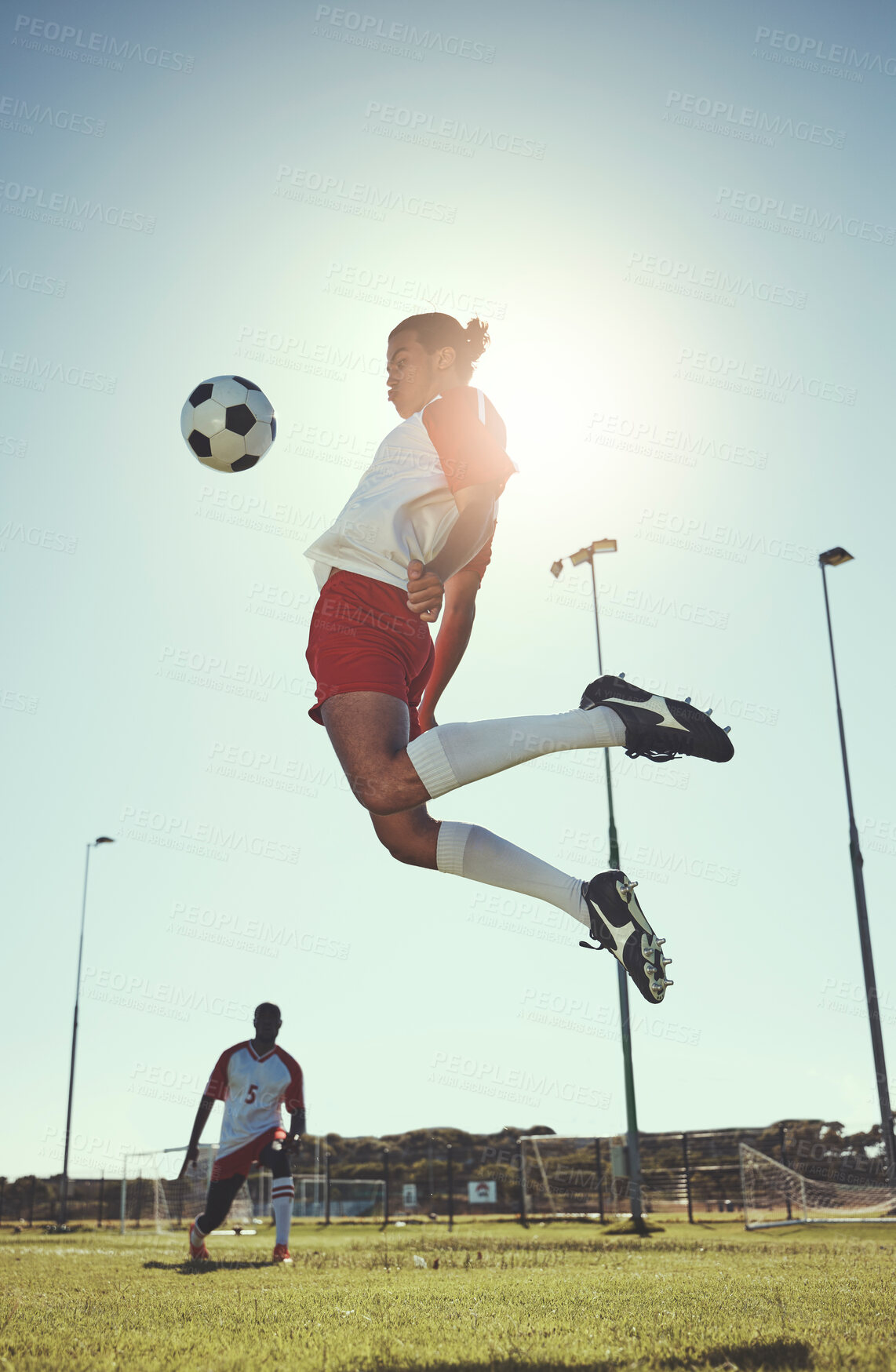 Buy stock photo Soccer, sports and training with a man athlete playing with a ball on a field or grass pitch for exercise and fitness. Football, jumping and workout with a male in a game or match for sport