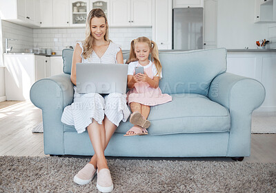 Buy stock photo Family, phone and laptop with a girl and mother on the sofa in a home living room together while working or on social media. Computer, email and communication with a woman and daughter in a house