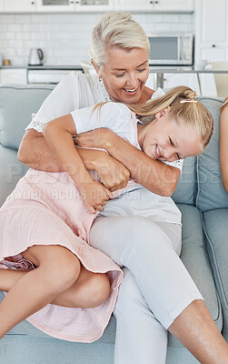 Buy stock photo Grandmother, family and child at home with a senior woman having fun, bonding and laughing for tickle and playing on living room sofa. Grandma and girl grandchild spending time in Australia house