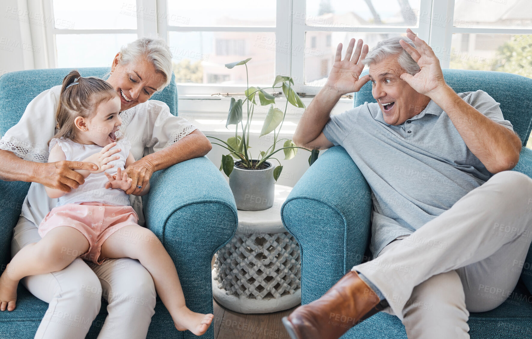 Buy stock photo Happy, grandfather and grandmother with child, excited and bonding being silly, goofy or funny in living room at home. Elderly man, senior woman or grandchild being playful, connect or laugh together