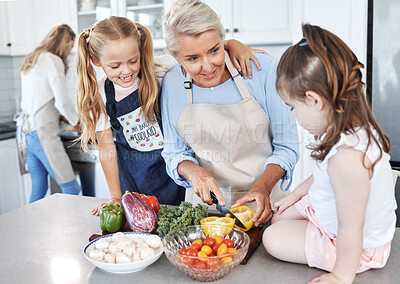 Buy stock photo Grandmother, children and cooking in the kitchen together with vegetables in the family home. Cutting, food and elderly woman in retirement teaching young girl kids to cook meal for lunch or dinner.