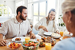 Food, family and couple eating at a table, happy, relax and bonding in their home together. Lunch, happy family and thanksgiving feast with cheerful people sharing a meal, fresh, cheerful and fun