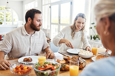 Buy stock photo Food, family and couple eating at a table, happy, relax and bonding in their home together. Lunch, happy family and thanksgiving feast with cheerful people sharing a meal, fresh, cheerful and fun