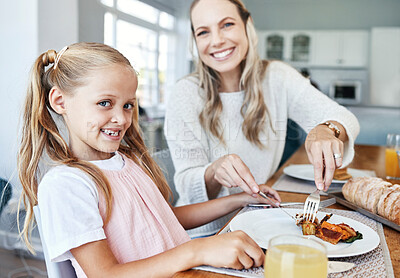 Buy stock photo Children, family and food with a girl and mother eating a meal at the dining room table at home together. Kids, lunch and love with a woman and daughter sharing a roast in celebration of an event