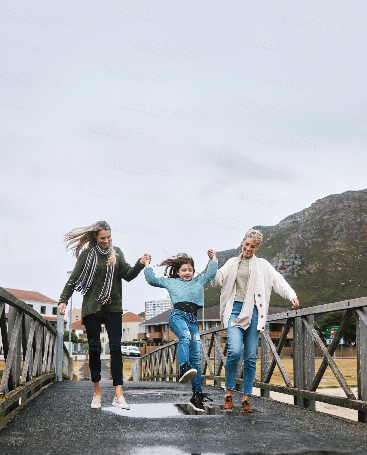Buy stock photo Happy, travel and family on outdoor walk while on a spring vacation, adventure or journey. Grandmother, mother and girl child walking on bridge together with happiness, fun and bond while on holiday.