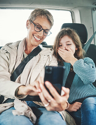 Buy stock photo Phone, surprise and mother with child on car journey, travel or road trip for adventure, bond or fun quality time together. Love, shock or transport for kid girl with happy mom streaming online movie