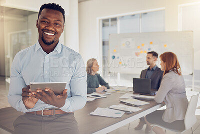 Buy stock photo Leadership, tablet and meeting with a black man CEO or manager sitting on a boardroom table with his team in the office. Technology, planning and strategy with a business leader ready for training
