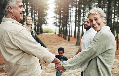 Buy stock photo Diversity, holding hands and family on forest nature walk for bonding, wellness or healthy outdoor holiday. Senior, elderly grandparents portrait for interracial love, care and trust on fun adventure