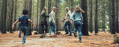 Buy stock photo Forest, big family and adventure with children, parents and grandparents walking in nature for outdoor hiking, fun and trees on wellness vacation. Running kids, travel and happy man and women in woods