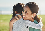 Happy, girl and kid hug mom for mothers day, love and relax at park outdoors for fun together in Colombia. Smile parent, laughing child and play for happiness, quality time and care in summer garden