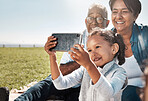 Selfie, phone and girl with grandparents in park for family, happy and technology in summer together. Smile, internet and online with old couple and child relax on grass for bonding and lifestyle 