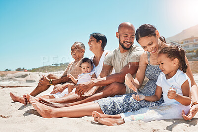 Buy stock photo Happy, family and relax with smile on beach for summer vacation and bonding time together in nature. Mother, father and grandparents with children relaxing on sandy shore smiling for holiday travel