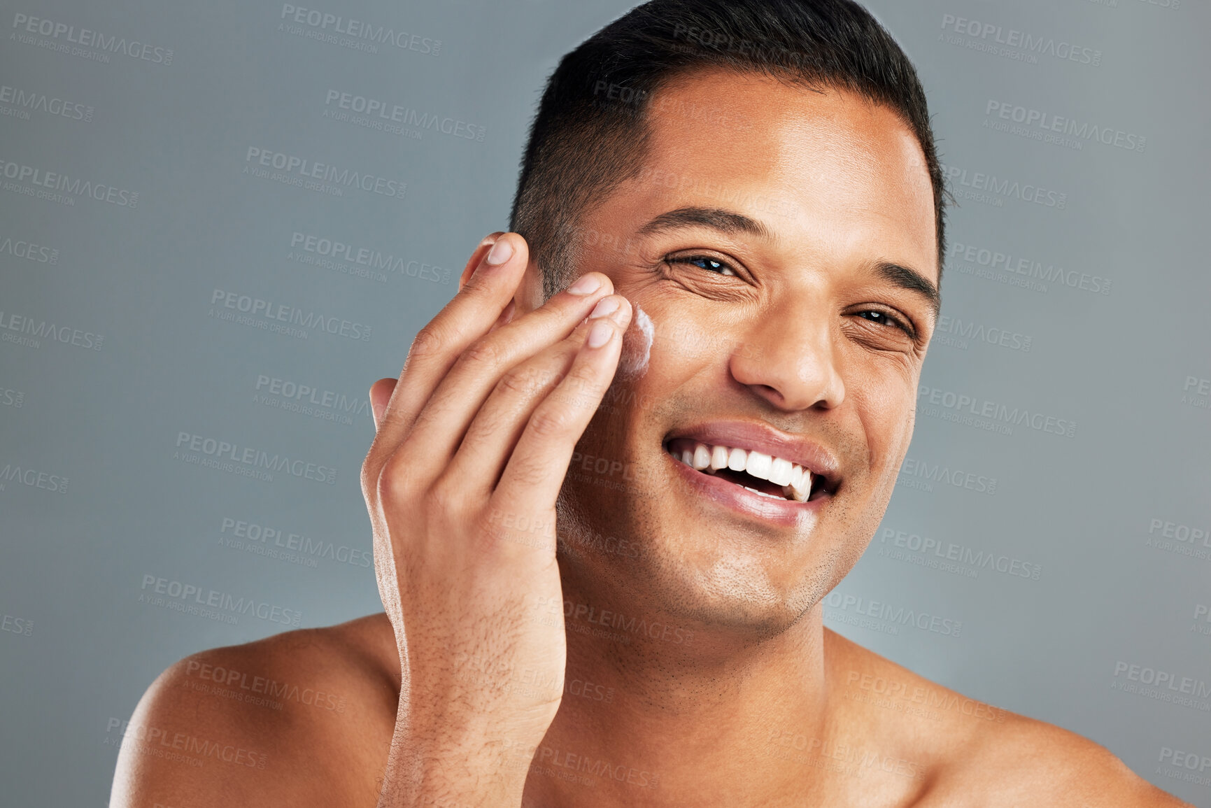 Buy stock photo Happy man, face cream skincare and portrait moisturizer, healthy aesthetic and glowing skin on grey studio background. Smile headshot guy facial product, dermatology cosmetics or clean body wellness