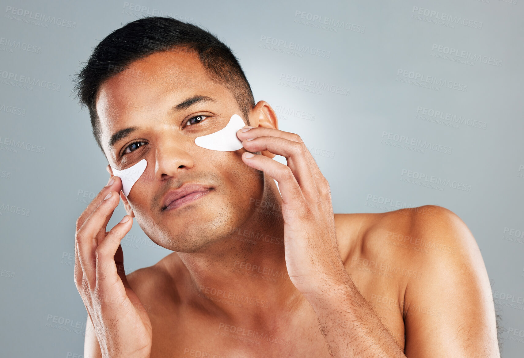 Buy stock photo Model, skincare and eye mask for man in portrait for health, wellness and cosmetics with grey backdrop. Face, cosmetic and facial for beauty, self love and self care with studio background for care