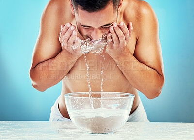 Buy stock photo Skincare, cleaning and man with water on face satisfied with hydration, grooming and hygiene. Wellness, cleansing and healthy routine of model for hydrated skin on blue studio background

