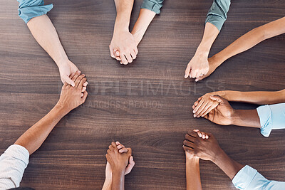 Buy stock photo Top view, holding hands or mental health support in group therapy meeting for psychology, trust or security. Men, women and diversity people in prayer circle for community, anxiety or depression help