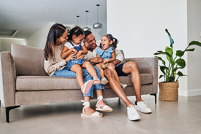 Buy stock photo Mother, father and children laughing on sofa together, having fun and bond on weekend. Love, affection and multicultural family on couch in living room. Happy parents playing with kids in family home