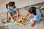 Girl children, knowledge growth and chess game on a living room carpet for home education. Kids in a household  for brain development, youth problem solving and strategy playing on a floor and rug