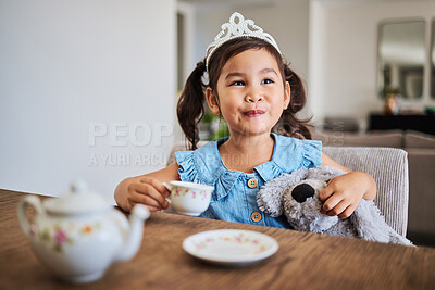 Buy stock photo Happiness, tea party and child in her home, playing, having fun with tea set and wearing a crown. Creativity, imagination and young Asian girl enjoying toys, teddy bear and toy kitchen utensils