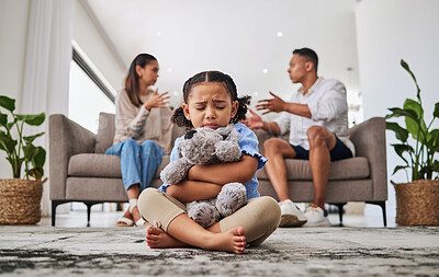 Buy stock photo Parents, fighting and sad girl in living room with teddy bear for support or comfort. Family, divorce and husband in argument with wife and scared kid sitting in fear, stress or depression on carpet
