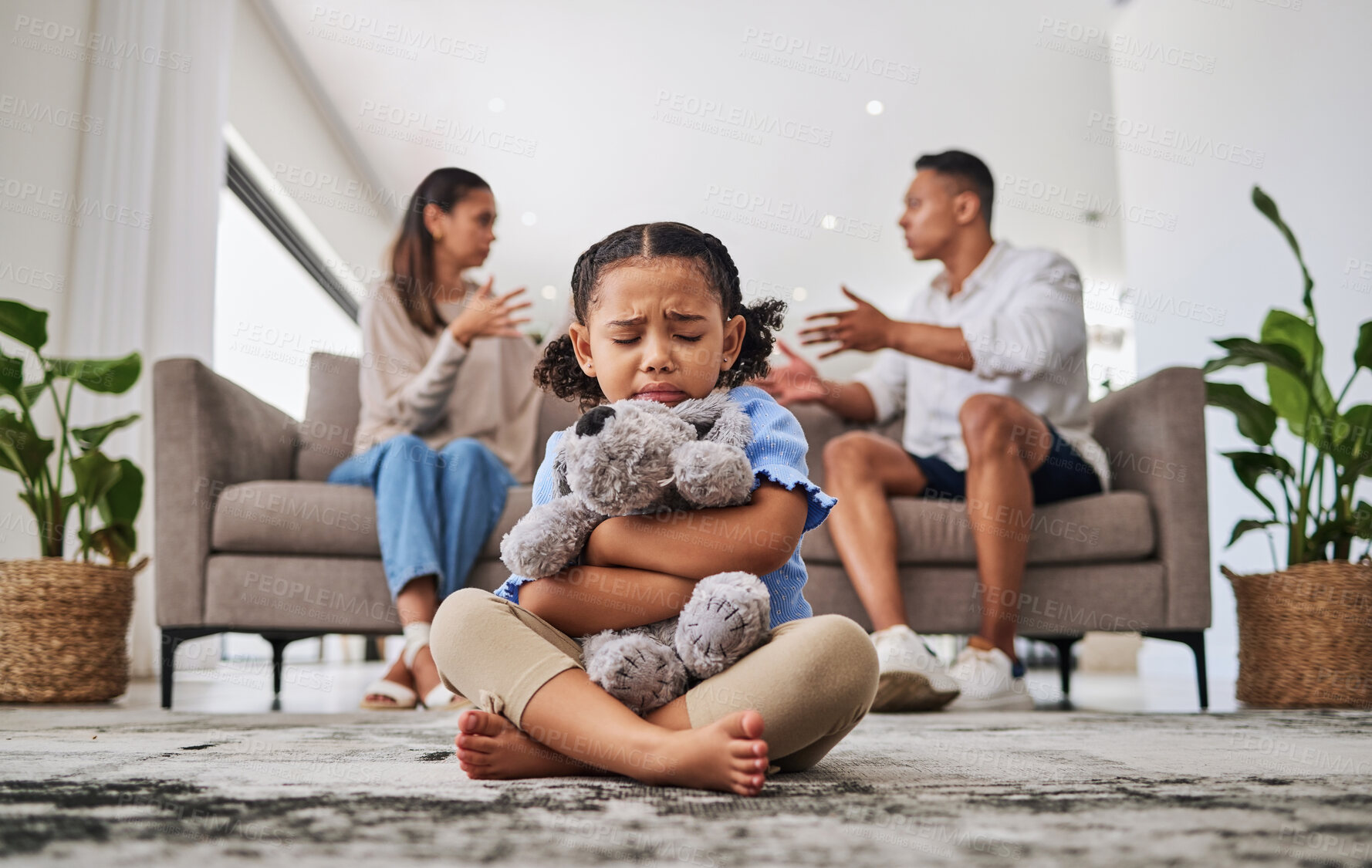 Buy stock photo Parents, fighting and sad girl in living room with teddy bear for support or comfort. Family, divorce and husband in argument with wife and scared kid sitting in fear, stress or depression on carpet
