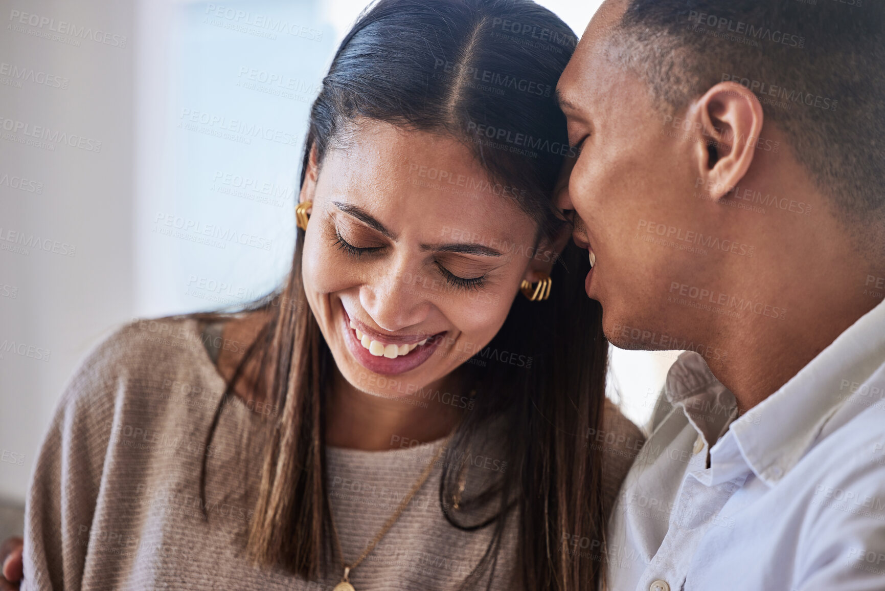 Buy stock photo Love, happy and couple whisper in ear for relationship, secret and romantic cuddle. Smile, relax and funny with woman listening to man and laughing at joke for care, marriage or date at home together