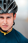 Sports man, cycling and face of cyclist looking ready, cool and determined while training outdoors. Mindset, motivation and portrait of athlete biking outside, proud, serious and fitness goal