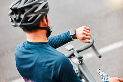 Buy stock photo Watch, fitness and man cycling in the city on a bike for cardio health, exercise and sustainable lifestyle. Athlete cyclist training with the time on tech with a bicycle on the street for motivation