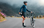 Sports, fitness and man stretching in a road during cycling workout, training and focus in nature. Bike, sport and performance preparation by athletic cyclist doing leg stretch before exercise