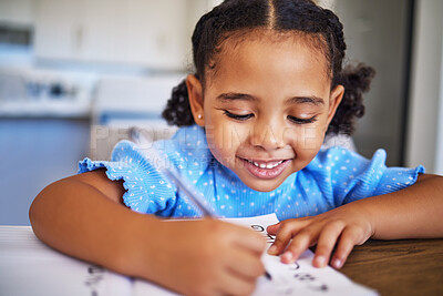 Buy stock photo Homework, drawing and child writing in a notebook for education, learning and knowledge in her house. Happy, smile and studying girl being creative in a book for school work at a table in her home