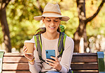 Woman, phone and travel with coffee for backpacking in nature adventure relaxing on a park bench in the outdoors. Happy female traveler in social media, browsing or texting for trip on smartphone