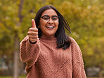 Thumbs up, like and Indian woman in park for outdoor support, volunteer in eco environment or green success. Thank you, yes or ok agreement hand sign of a girl in portrait with countryside trees